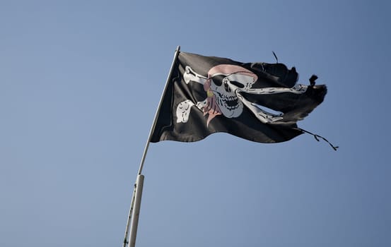 Pirate flag against the blue sky seen in a marina in Montenegro - Europe.