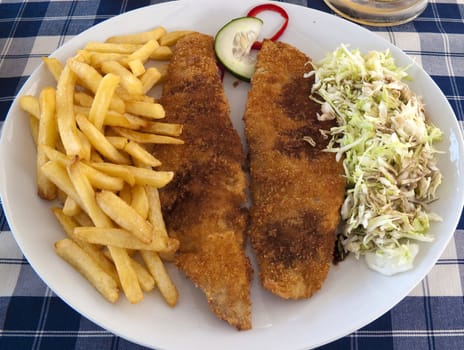 A plate of fish and chips to a glass of beer.