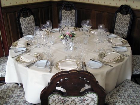 Elegant laid table for eight. Natural lightening from the windows.