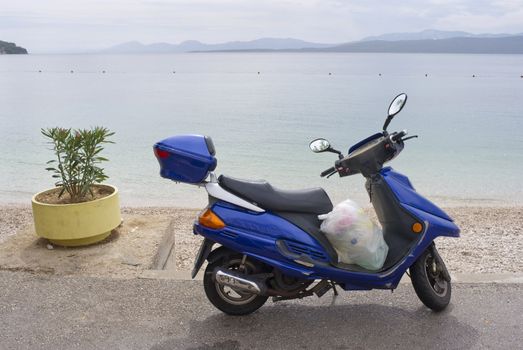 Moped parked near the beach by the Adriatic Sea - Croatia.