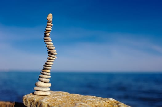 Pile of small pebbles in the balance on the seacoast