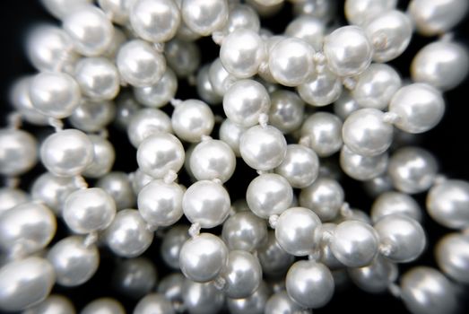 Closeup necklace pearls on black background.