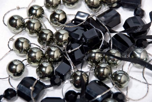 Closeup black pearls necklace on the white background.