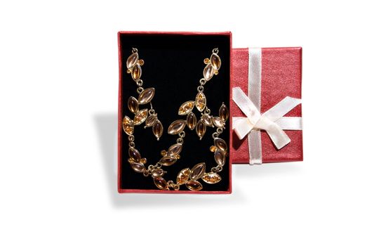 Gold jewelry sets in open boxes, on white background