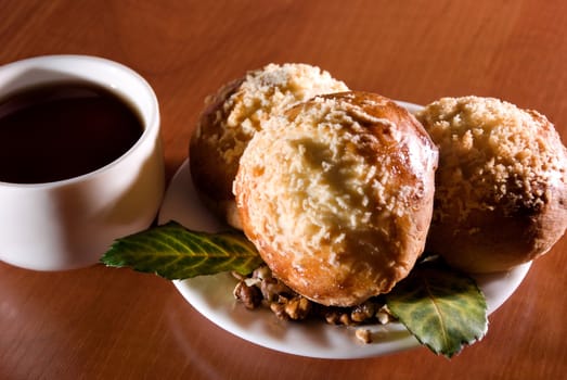 Cup of tea and saucer with sweet dessert of fresh cake.