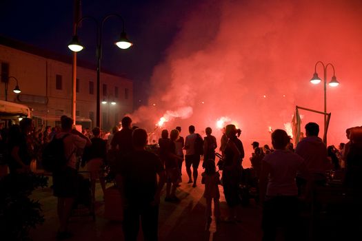 Red firework celebration after a Croatian wedding.