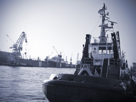 Towing boat and dock - Harbor of hamburg, Germany.