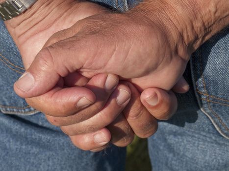 Workers hands in low evening ight.