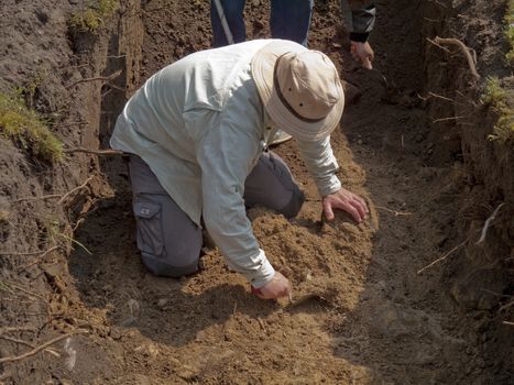 Archaeologist excavating outsite Nyborg Castle, Funen, Denmark.