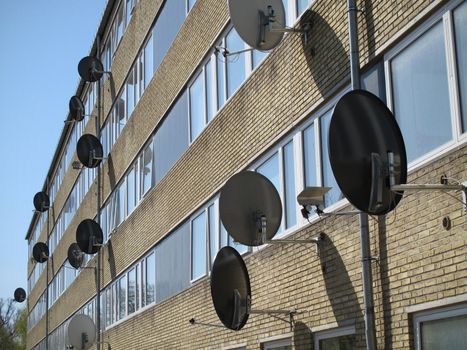 Facade of Danish block of flats with satellite dishes.