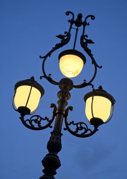 Nice old lamp at dusk. Seen in Lorezo - region of Marche, Italy.