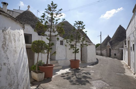 Trulli roofs against a blue sky. Alberobello, Apulia - Italy. A trullo is a traditional Apulian stone dwelling with a conical roof. The style of construction is specific to Itria Valley - region of Apulia.
