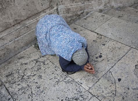 Anonymous beggar in the street of Rome, Italy.