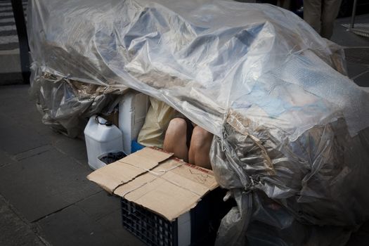 Anonymous homeless in his urban selfmade shelter -  Rome, Italy.