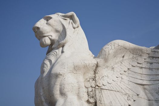 Winged lion seen against the blue sky - a detail of the Victor Emmanuel monument at Piazza Venezia -  Rome, Italy. Build after a design by Giuseppe Sacconi as a tribute to the first king of united Italy - Victor Emmanuel II.