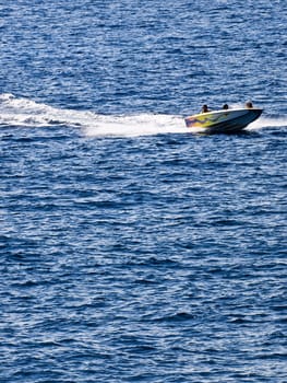 Family riding a powerful speedboat on the waves in Malta