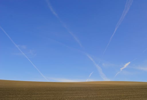 brown farmland with clear blue sky