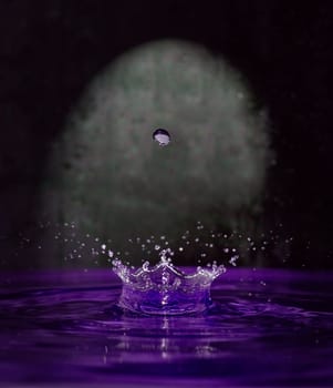 drop of water hanging over splash fontain