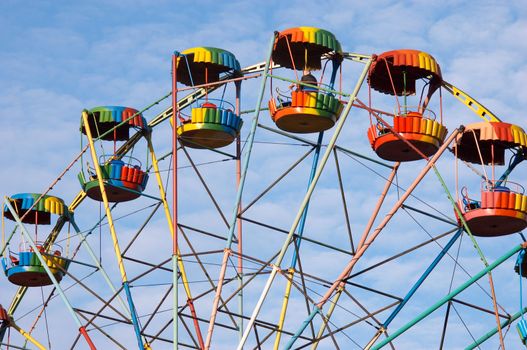 silhouette of colorful joy wheel in amusement park
