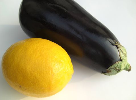 lemon and aubergine egg-plant on white background, entire fruits