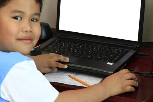 Young boy with computer - put your text on balnk monitor.