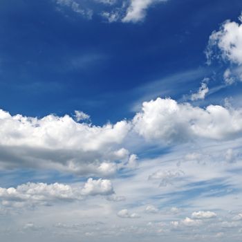 white fluffy clouds in the blue sky                                    