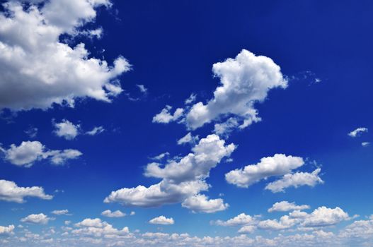 white fluffy clouds in the blue sky                                    