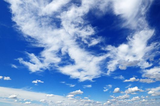 white fluffy clouds in the blue sky                                    