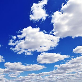 white fluffy clouds in the blue sky                                    