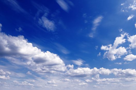 white fluffy clouds in the blue sky                                    