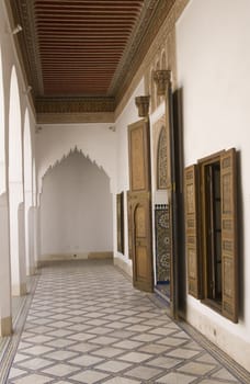 Ornate corridor and doorway inside the 19th century El Bahia Palace in Marrakesh, Morocco.