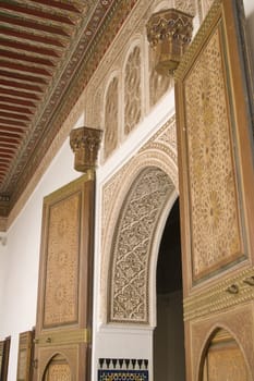 Ornate entrance arch and doorway inside the 19th century El Bahia Palace in Marrakesh, Morocco.