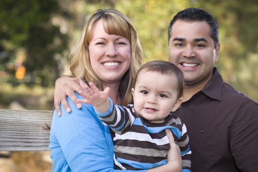 Happy Mixed Race Ethnic Family Posing for A Portrait in the Park.