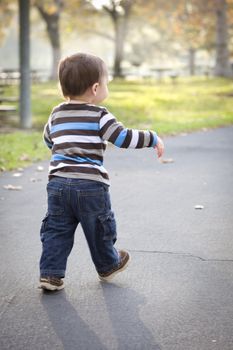 Happy Young Baby Boy Walking in the Park.
