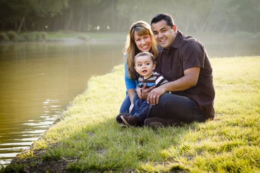 Happy Mixed Race Ethnic Family Posing for A Portrait in the Park.