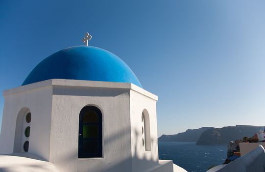 Orthodox temple in Oia, Santorini, Greece at daytime with blue sky