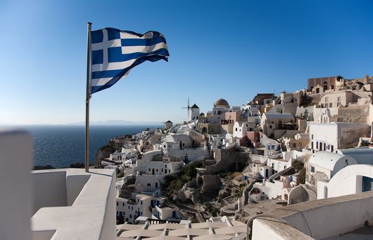Greece national flag in Oia at Santorini over blue sky
