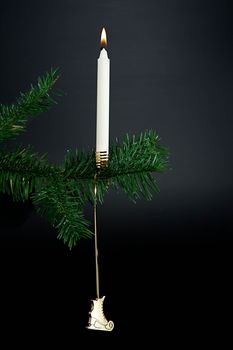 Christmas decoration. Candle light on a christmas tree.