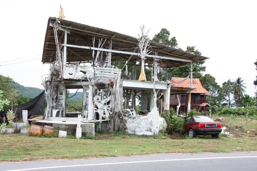 unusual house in Thailand, built of the material at hand.