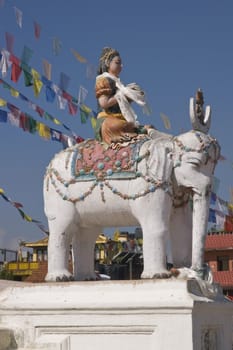 Boudhanath Stupa. Statue of religious deity on a white elephant. Kathmandu, Nepal