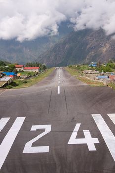 Small aircraft landing at the remote airfield at Lukla in the Nepalese Himalayas. Gateway to Mount Everest