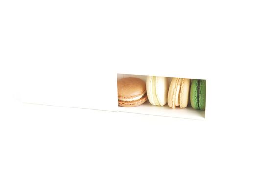 Colorful macaroons in a white box
