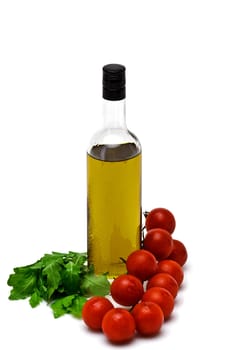 bottle of olive oil with cherry and arugula on white background