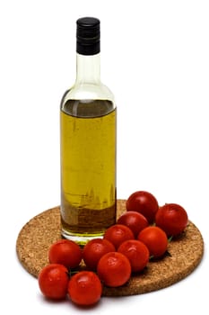 bottle of olive oil with cherry on white background