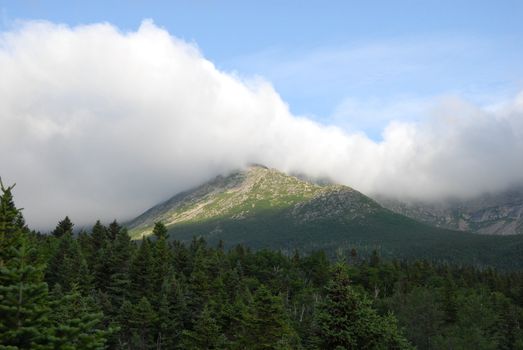 A view of Mt. Kathdin in Maine during the summer time. With clouds rolling over.
