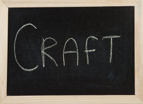 A black board with a wooden frame and the word 'CRAFT' written in chalk.