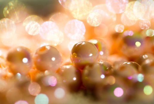 beige colored beads shine under sunlight  and LED light