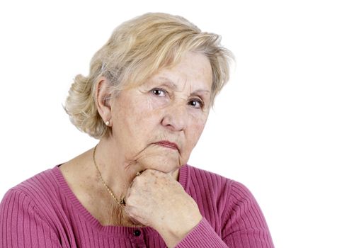 Portrait of a serious senior woman holding her chin looking at the camera, isolated on white.