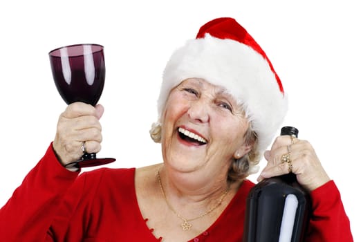 Holiday concept: smiling senior woman or grandmother is wearing Santa Claus's hat and having lots of fun drinking at the Christmas party