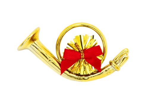 Golden christmas trumpet  and red ribbon on a white background 